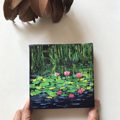 a painting of water lilies on a canvas