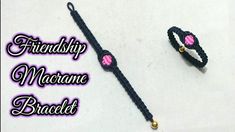 two black and white bracelets with pink hearts on them sitting next to each other