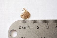 14k gold filled SHELL Pendant Charm,Gold Filled Sea Shell Seashell, ocean sea life Charms, Gold Filled Scallop Shell Charm, Bridesmaid Charm - Wonderful for beach, bridal, personalize designs - Light weight ☑ Quantity: 1 pc ☑ Approximate Measurements: 14 x 11mm (including loop) ☑ Surface: Glossy/ Shiny Finish ☑ Material: 14k gold filled ☑ Made to order ☑ Made in USA ☑ This charm does come in larger quantities than listed. Please message me for a custom wholesale amount. Gold Shell-shaped Jewelry With Starfish Charm, Ocean-inspired Gold Shell With Lobster Clasp, Elegant Gold Shell With Lobster Clasp, Gold Nickel-free Shell As Gift, Gold Ocean-inspired Shell, Gold Ocean-inspired Shell For Jewelry Making, Handmade Gold Round Shell, Gold Ocean-inspired Shells For Jewelry Making, Nickel-free Gold Shell