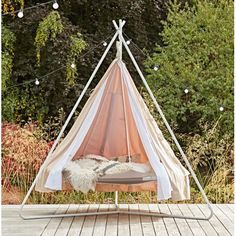 a teepee is set up in the middle of a wooden deck