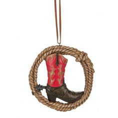 a cowboy boot ornament hanging from a rope