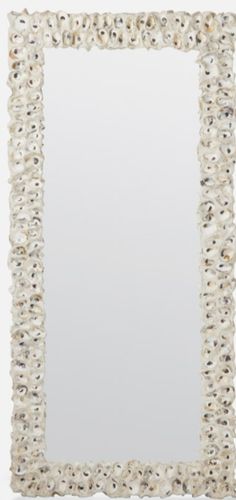 a white square mirror with shells on the bottom and sides, in front of a white background