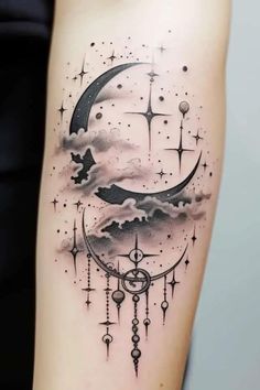 a woman's arm with a crescent and stars tattoo on it