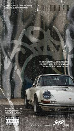 a white car parked in front of a graffiti covered wall