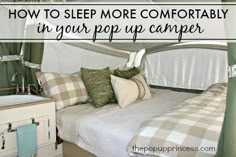 a camper with pillows on the bed and text overlay reading how to sleep more comfortably in your pop up camper