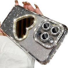 a woman holding up a silver case with an oven design on the front and sides