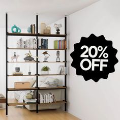 a book shelf with books on it next to a wall that has a sign reading 20 % off