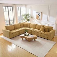 a living room with a large sectional couch and coffee table in the middle of it