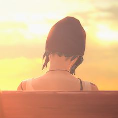 a woman sitting on top of a wooden bench next to the ocean in front of a sunset