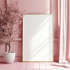 a pink room with an empty frame and flowers in a white vase on the floor