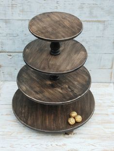 three tiered wooden tray with nuts on top