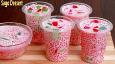 four cups filled with liquid sitting on top of a cutting board