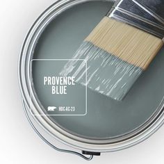 a paint can with a brush in it and the words providence blue painted on it