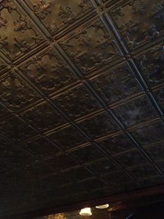 an ornate ceiling in a restaurant or bar