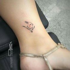 a small bird tattoo on the ankle