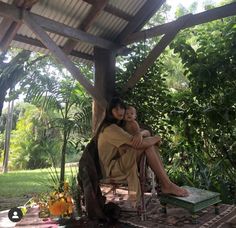 a woman sitting on top of a chair next to a child