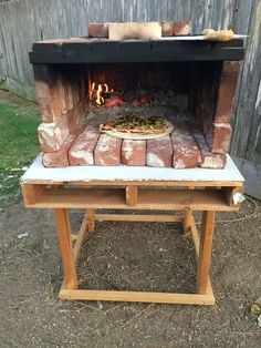 an outdoor pizza oven with several different types of food cooking in it's open doors