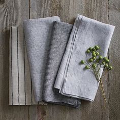 four folded linens sitting on top of a wooden table