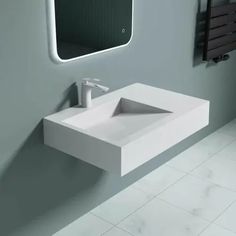 a white sink sitting under a bathroom mirror