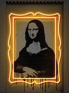 a painting of a woman's face on a brick wall with neon lights around it