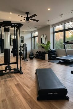 the gym is clean and ready for people to use it as an exercise center in this modern home