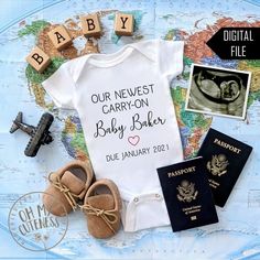 a baby bodysuit, passport, and shoes are on top of a world map