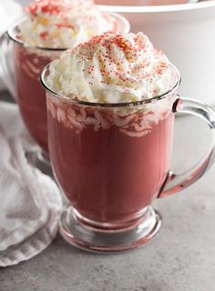 two mugs filled with hot chocolate and whipped cream