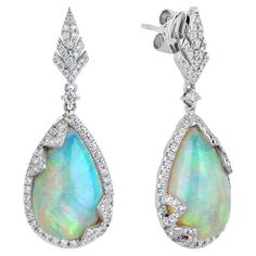 The Following Item we are offering is a Rare Important Radiant 18KT Gold Large Rare Fancy Gorgeous Opal Earrings. Earrings are comprised of LARGE Gorgeous Fancy Opals surrounded and adorned with Beautiful Glittering Diamonds!!! T.C.W. Approx 10CTS!!! These Gorgeous Earrings a Rare Sample Pair from a Private Manufacturer that sold to Important 5 Star Hotel and Fine Jewelry Stores. NWT Retail Price: $15,000.00!! Luxury Heirloom Gemstone Earrings, Luxury Exquisite Gemstone Earrings, Luxury Hallmarked Pear-shaped Diamond Earrings, Gia Certified Drop Jewelry For Formal Occasions, Luxury Pear-shaped Gemstone Diamond Earrings, Luxury Pear-shaped Diamond Earrings With Gemstones, Formal Platinum Earrings With Gemstone, Formal Platinum Gemstone Earrings, Luxury Gia Certified Teardrop Jewelry