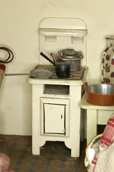 an old fashioned stove with pots and pans on it