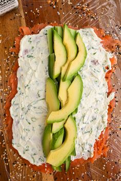 an avocado is sliced into pieces on top of some sort of cheese and sauce