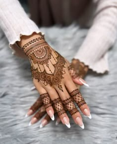 a woman's hand with hennap on it and her hands painted white