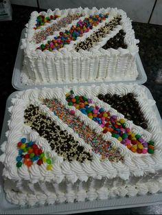 two cakes with white frosting and sprinkles on them