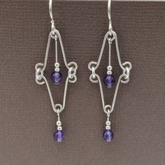 "I think of these as my \"wire lace\" earrings!  They are feather weight, which means they are so comfortable. These beautiful earrings feature small amethyst beads. Amethyst is a birthstone for February. They are 2 1/8\"  long from the top of the ear wire to the bottom of the earring. Amethyst is a purple form of quartz, which has been used for making jewelry for centuries. It is mined all over the world, with some of the largest mines in Brazil and Austria. It was named for the Greek word for Earring Inspo, Native Beading, Lace Earrings, Earring Ideas, Diy Wire Jewelry