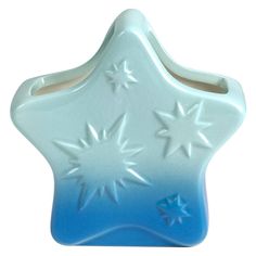 a blue and white star shaped toothbrush holder on a white background with stars in the middle