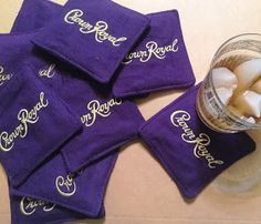 six purple towels sitting next to a glass filled with marshmallows