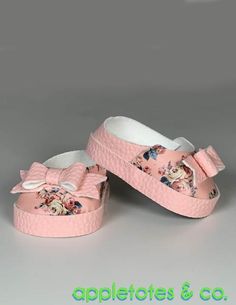 a pair of pink shoes with flowers on them