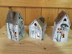 three small houses are sitting on a table