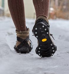 a person wearing hiking shoes in the snow