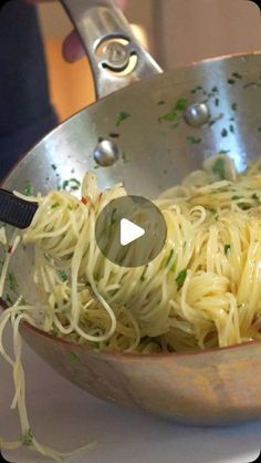 a pan filled with pasta and sauce on top of a table