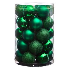 green christmas ornaments in a clear glass container