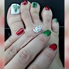 two feet with different designs on them and one has red, white and green nail polish