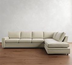 a white couch sitting on top of a wooden floor