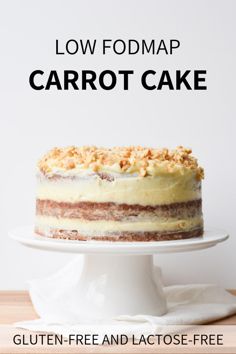 a cake sitting on top of a white plate next to a wooden table with the words low fodmap carrot cake