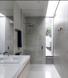 a bathroom with two sinks and a large mirror