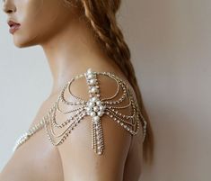 the back of a woman's bra with pearls and beads on her chest,