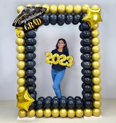 a woman standing in front of a balloon frame