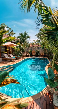 an empty swimming pool surrounded by palm trees