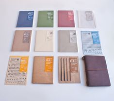 several notebooks are arranged on a white surface with different colors and designs in them