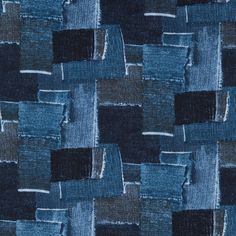 an up close view of blue and black fabric with squares on it's surface