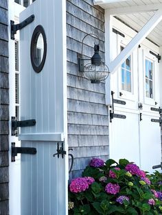 the front door of a house with flowers in bloom